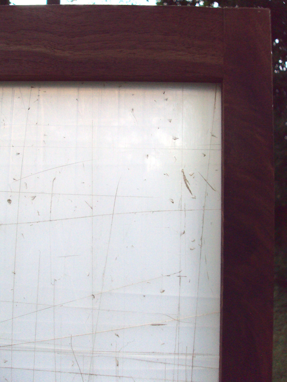 Tri-panel privacy screen made from a translucent salvaged cutting mat framed in black walnut