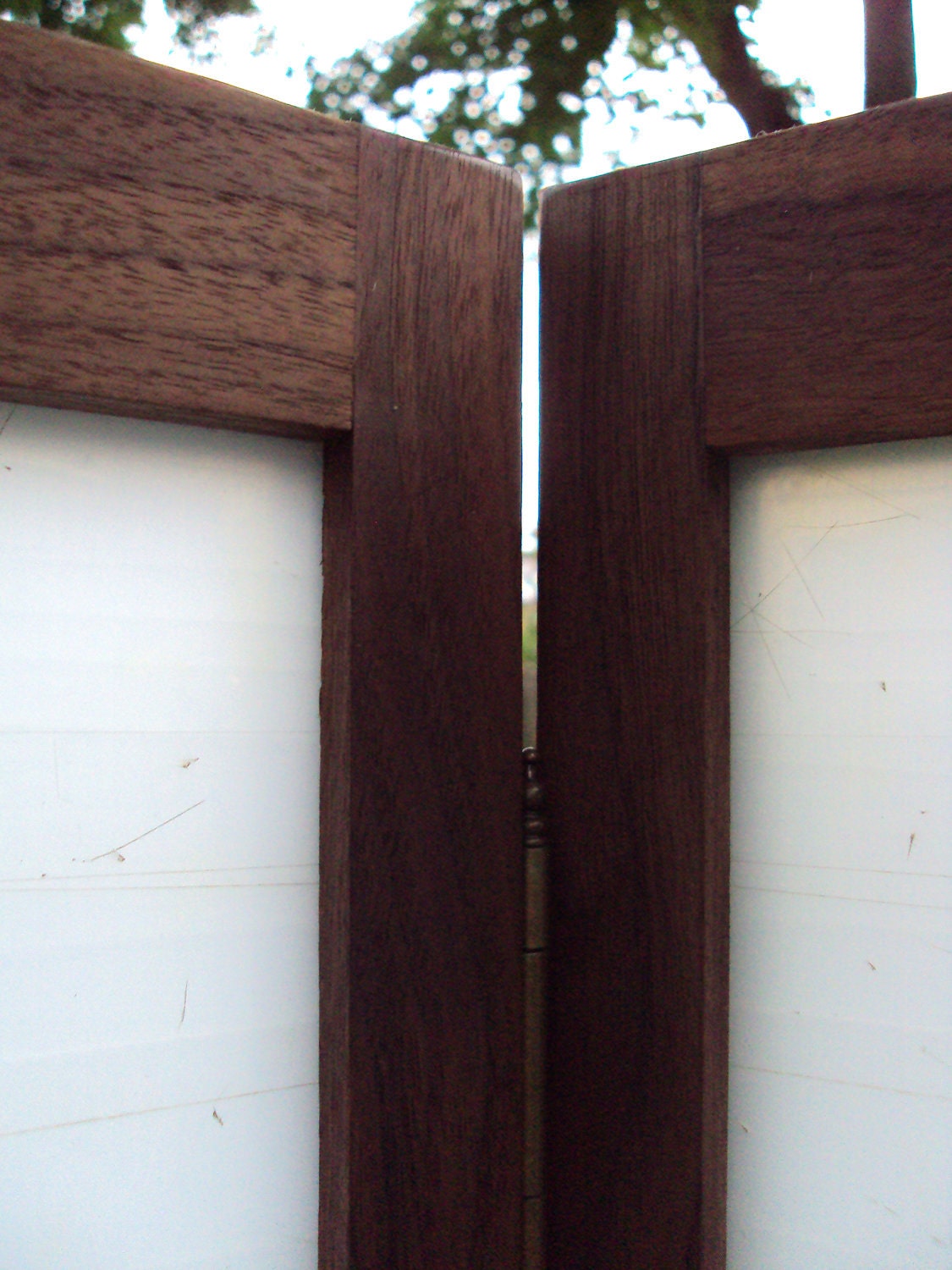 Tri-panel privacy screen made from a translucent salvaged cutting mat framed in black walnut