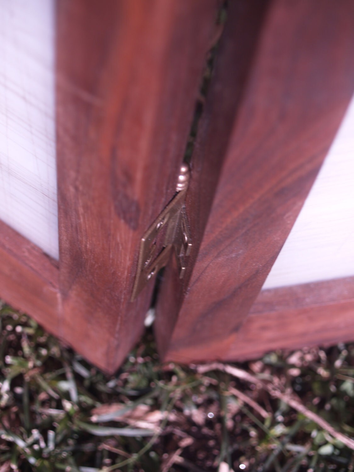 Tri-panel privacy screen made from a translucent salvaged cutting mat framed in black walnut