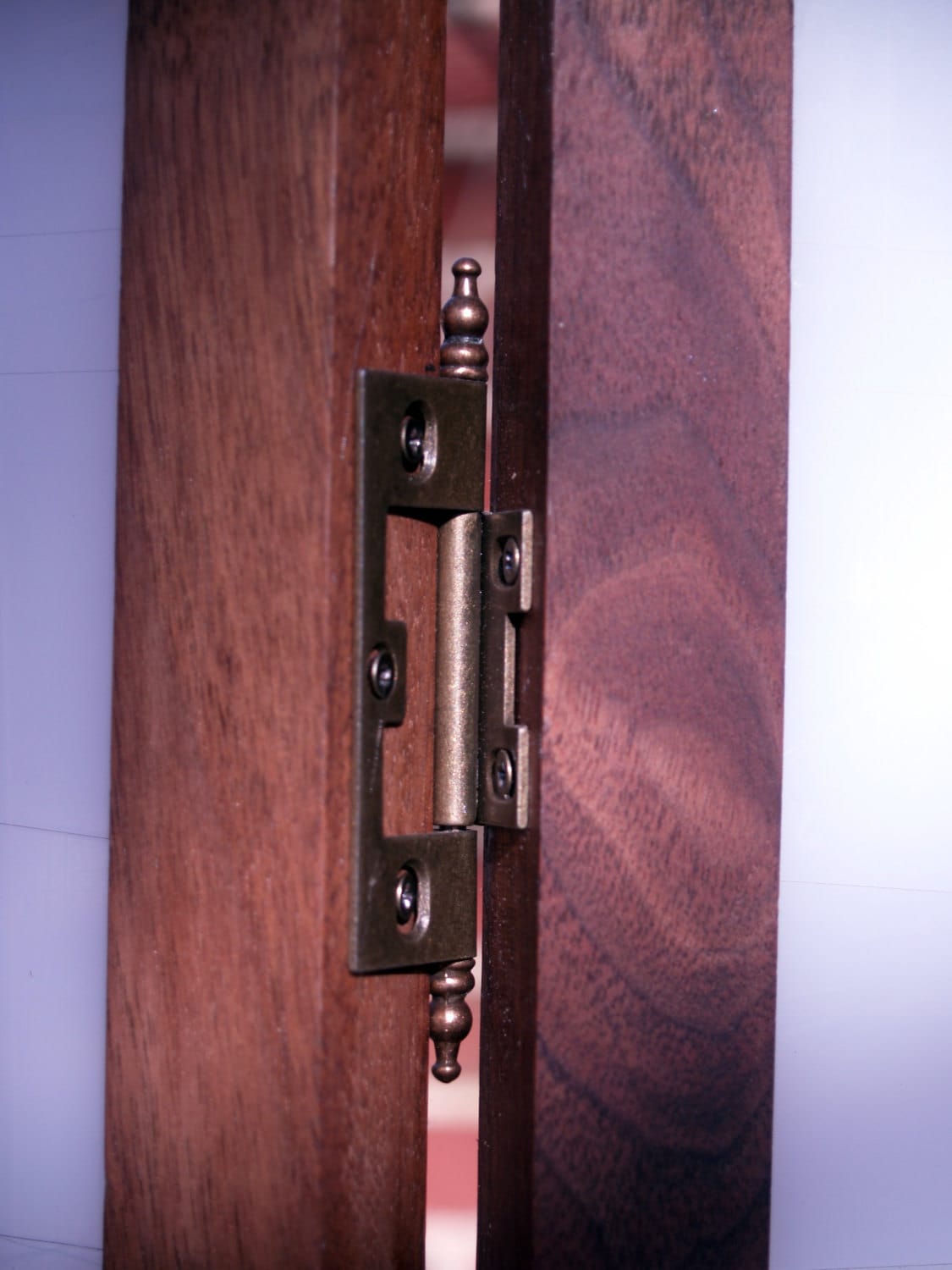 Tri-panel privacy screen made from a translucent salvaged cutting mat framed in black walnut