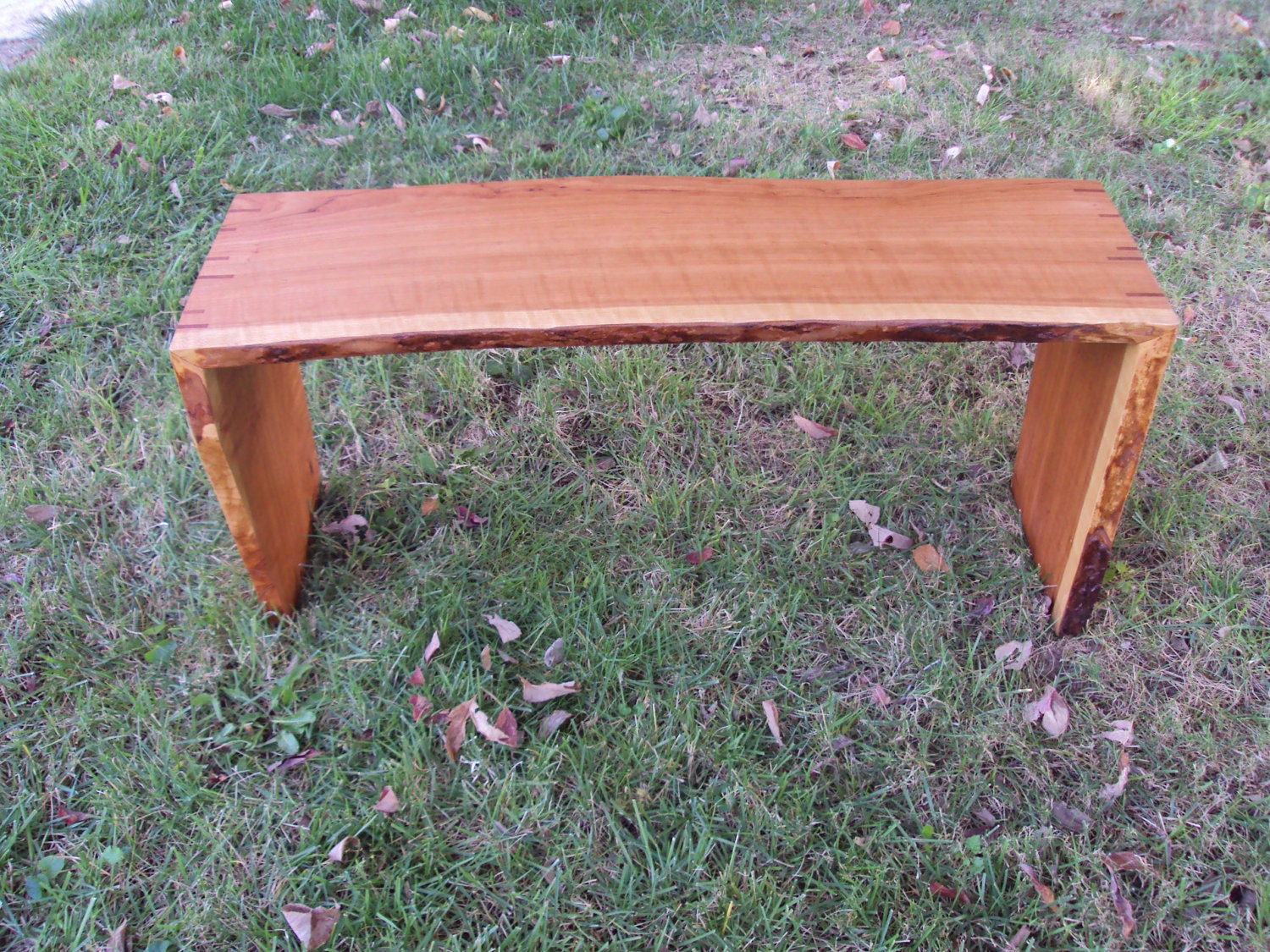 Live-edge cherry bench with natural finish and spline-mitered joinery