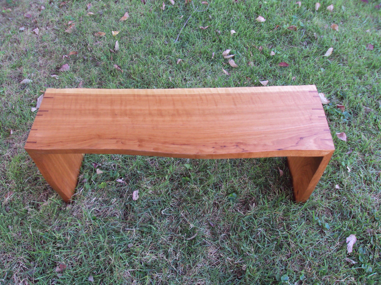 Live-edge cherry bench with natural finish and spline-mitered joinery