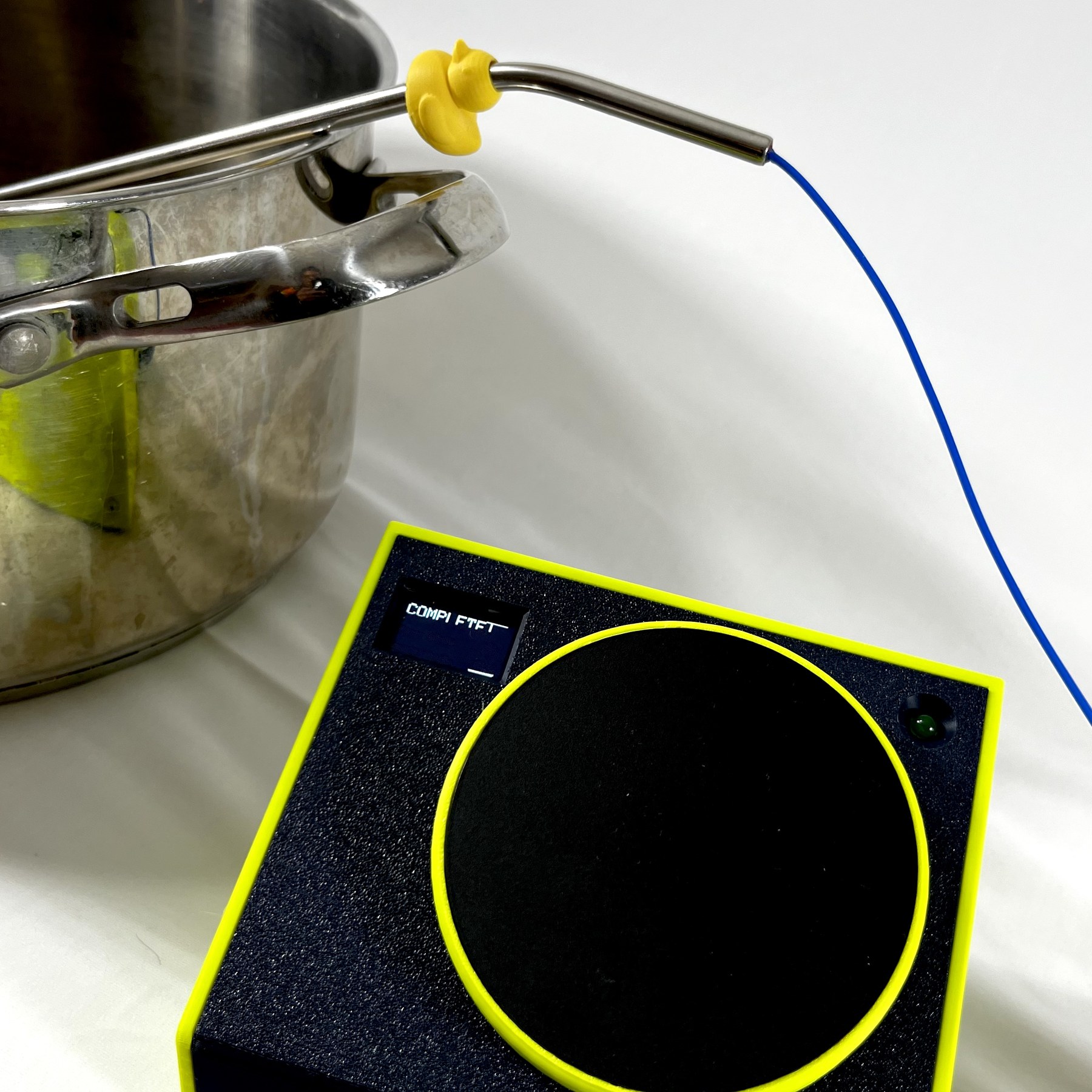 The timer running next to a stockpot of simmering green sauce