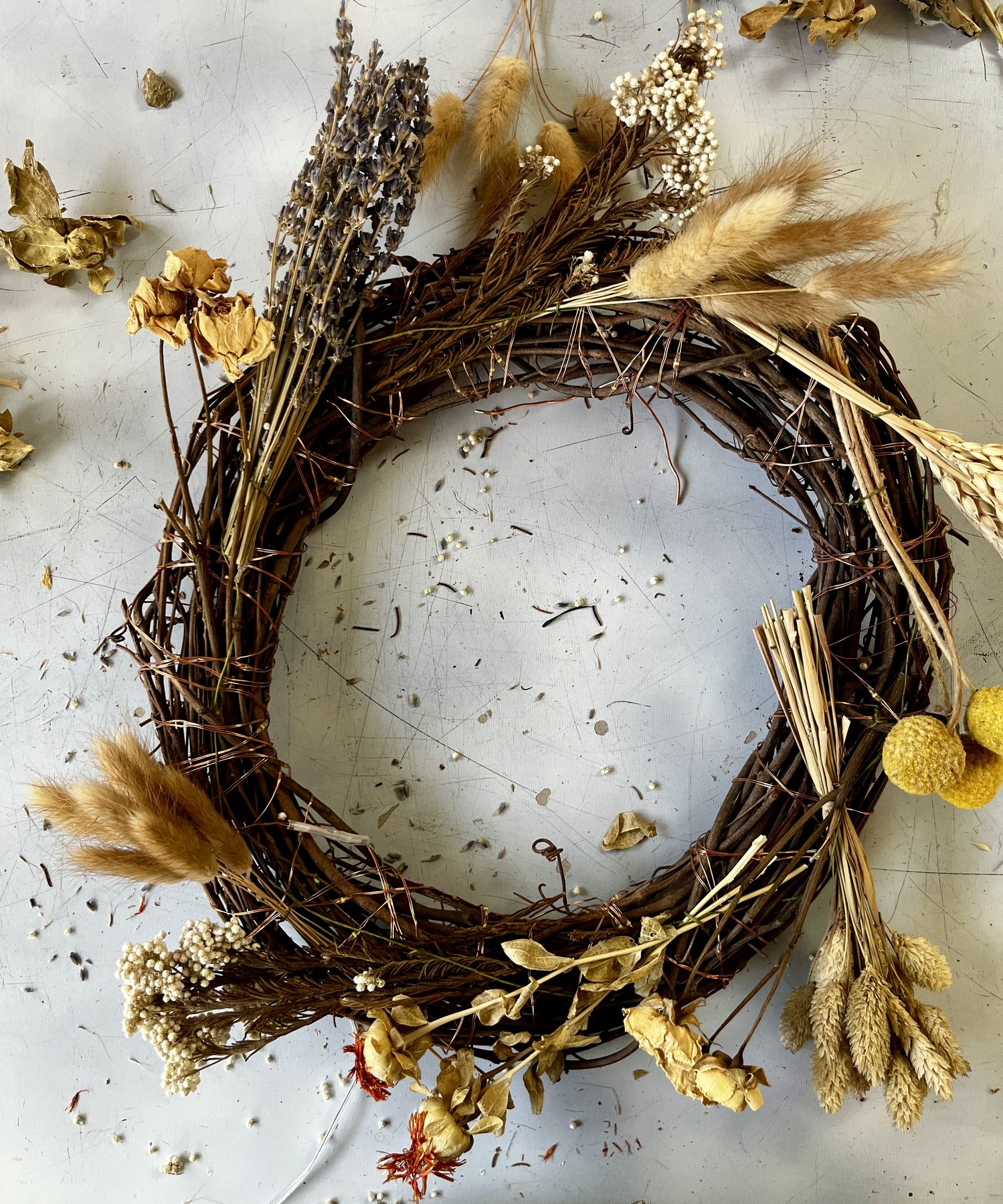 The wreath partly filled, dried material worked around two thirds of the ring